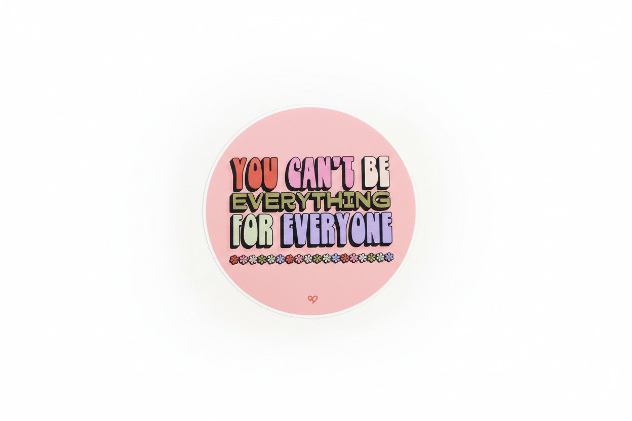 Round sticker with motivational text 'You can't be everything for everyone' on a pink background